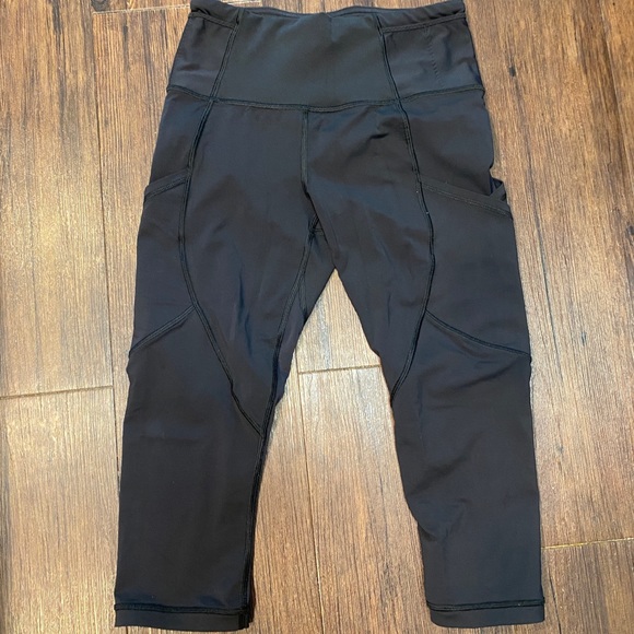 Lululemon black capris w/ pockets and mesh. Size 4 - Picture 2 of 4